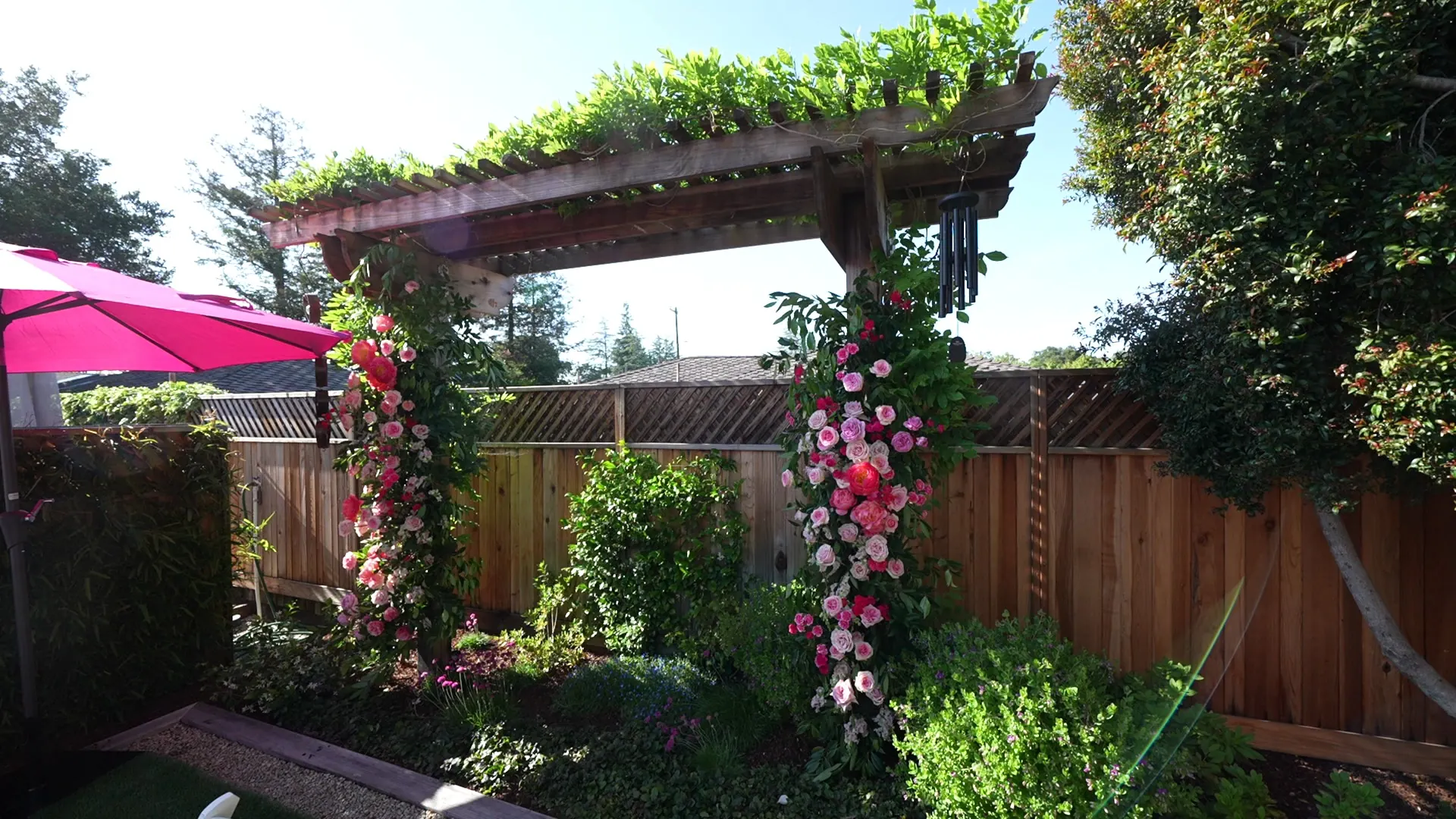 Pergola and floral arch framing an outdoor reception in Atherton