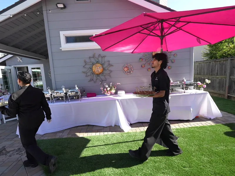 Backyard buffet being set up before a Woodside dinner