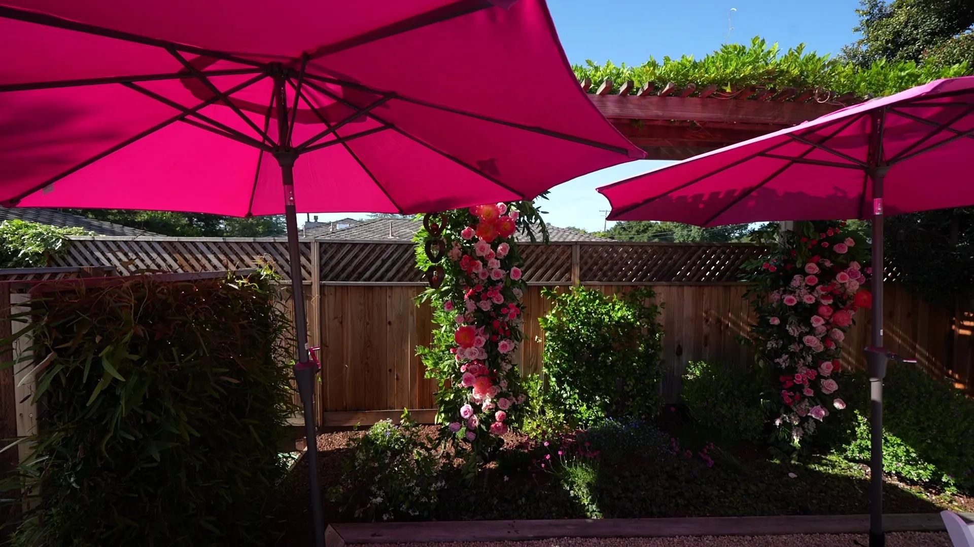 Floral arch beside a shaded patio at a Los Altos backyard party