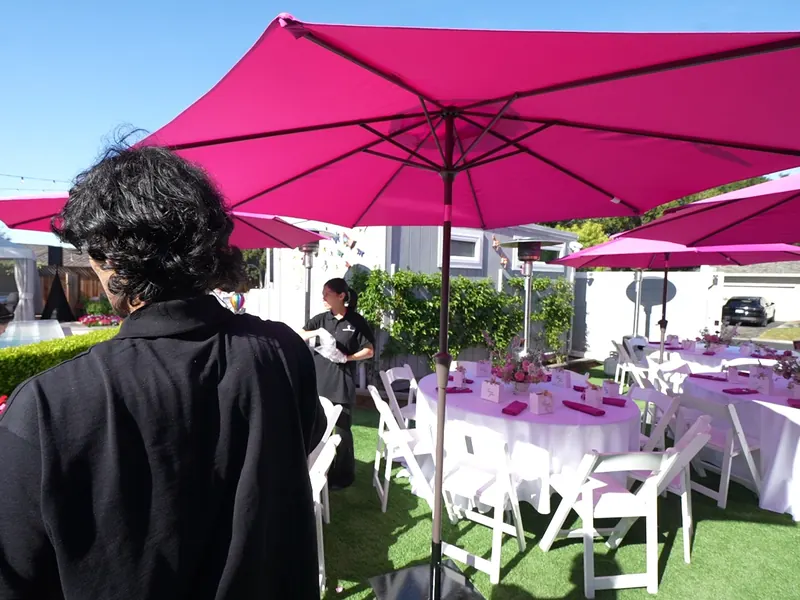 Lawn tables and umbrellas set for an Atherton daytime party