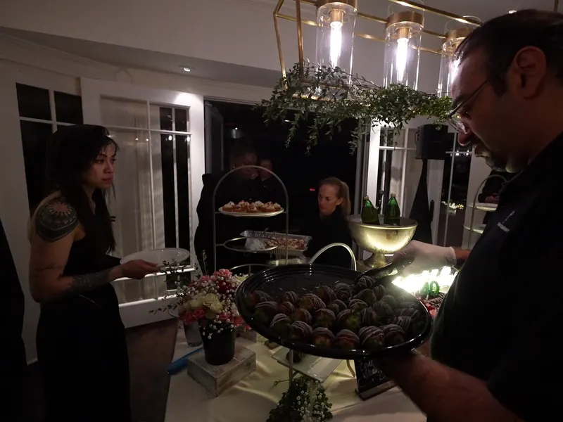 Server carrying a dessert tray through a Menlo Park party