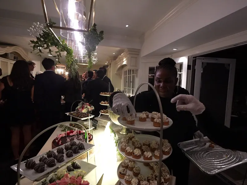 Server presenting a dessert tray at a Woodside evening event