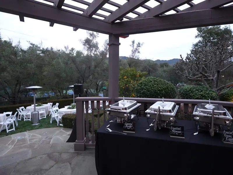 Tables set under a pergola on the lawn for a Sunnyvale dinner