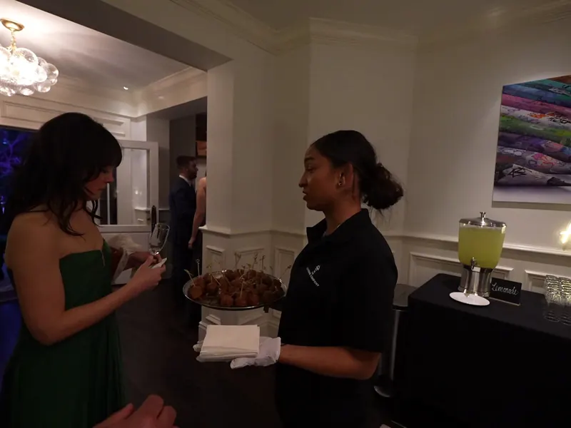 Server offering a tray of bites to guests at a Palo Alto evening event