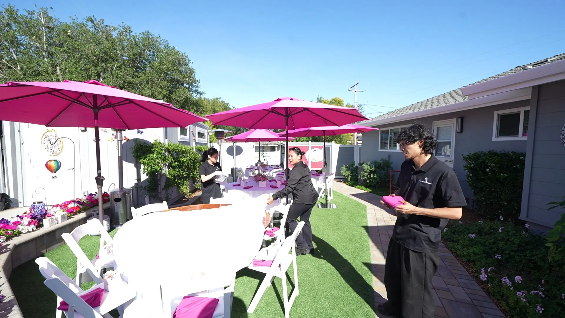 Attendant working a shaded patio buffet at a Redwood City party