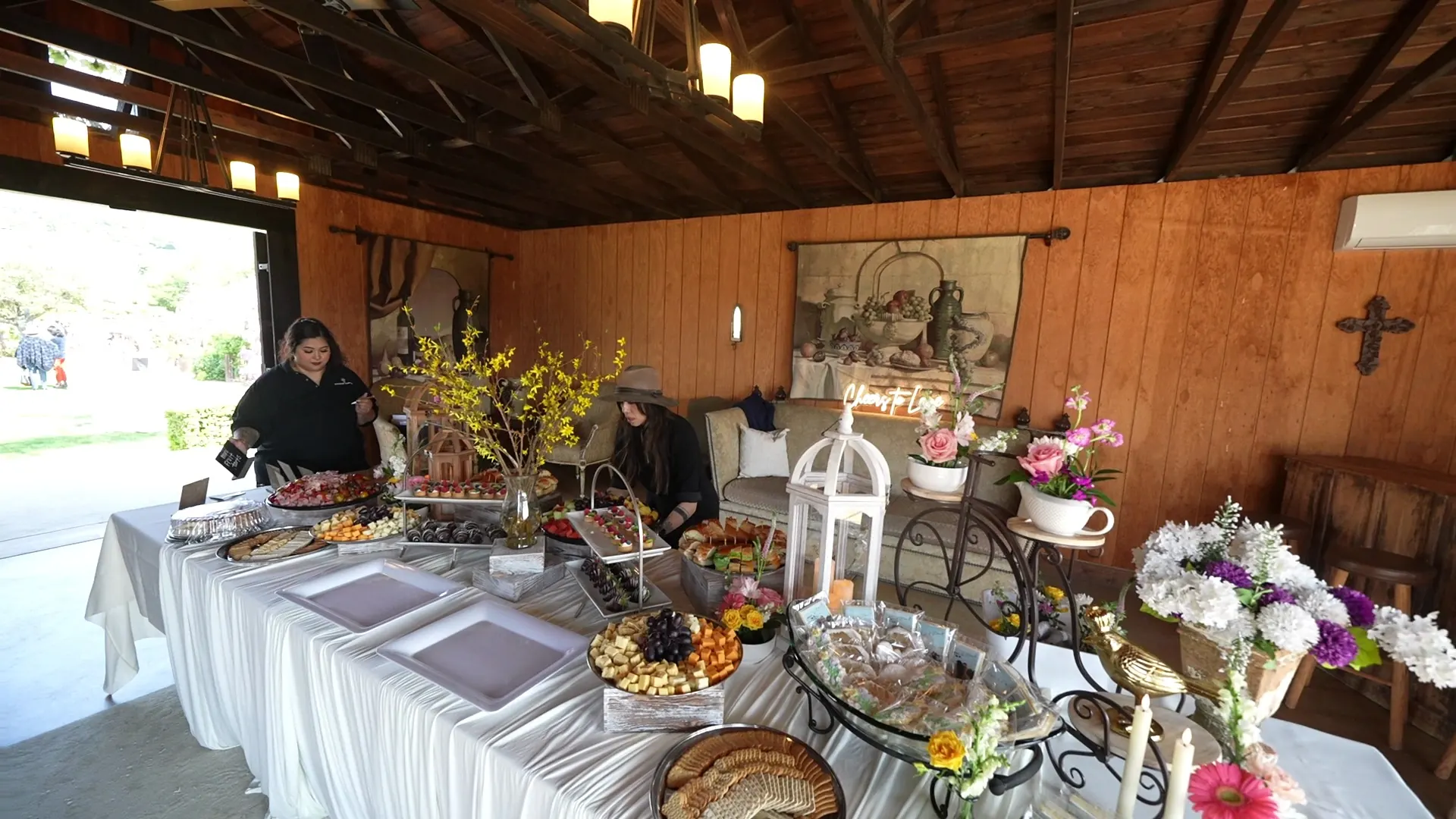 Grazing table of cheeses, fruit, and florals set for a Palo Alto reception
