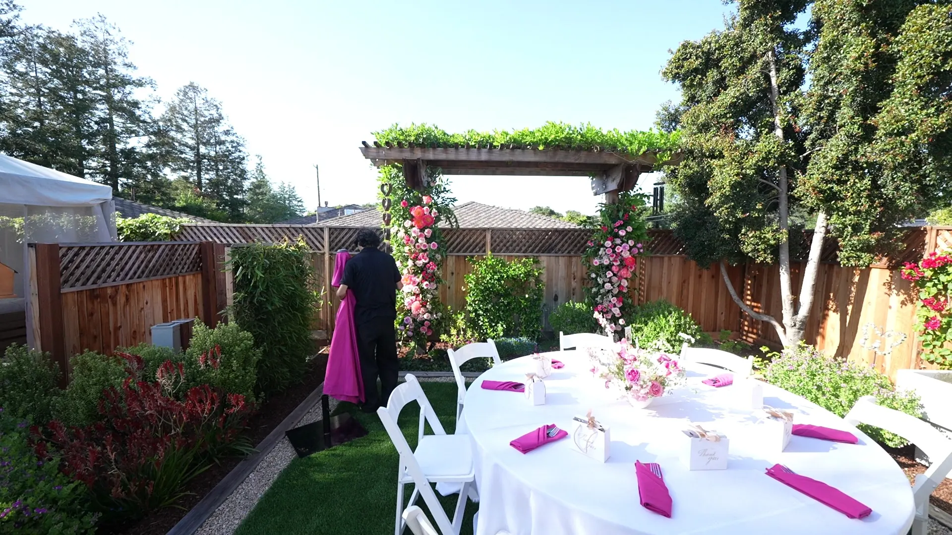 Garden arch and set tables ready for a Mountain View backyard party