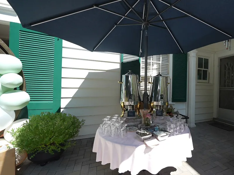 Beverage station set beneath an umbrella at a Redwood City gathering