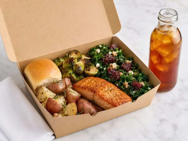 Palo Alto Catering Company corporate meal featuring a balanced combination of salmon, vegetables, salad, bread, and bottled iced tea.