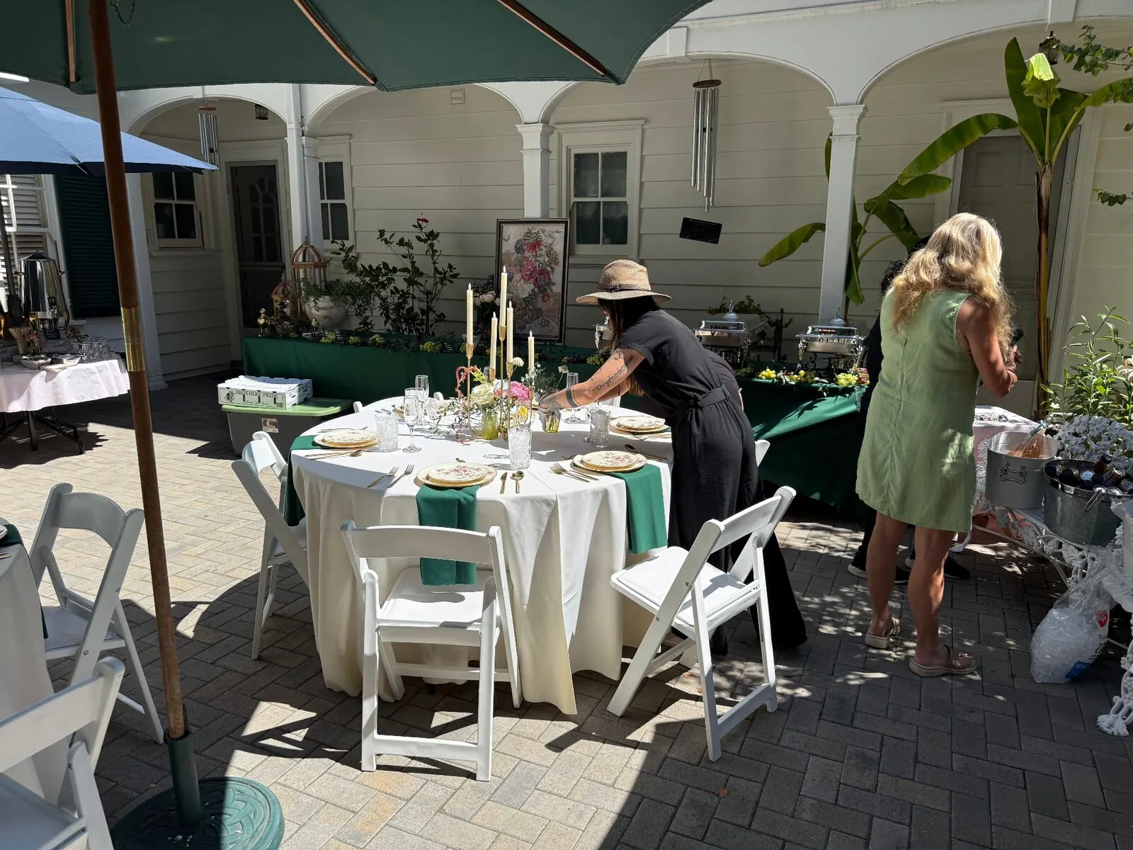 Courtyard rounds in emerald cloth with upgraded rental chairs, stemware and full settings
