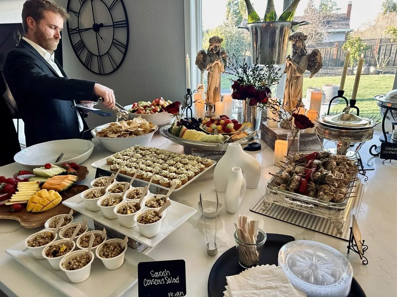 Elegant buffet of salads, skewers, and fresh fruit platters styled on linened tables at a Mid-Peninsula reception by Palo Alto Catering Company