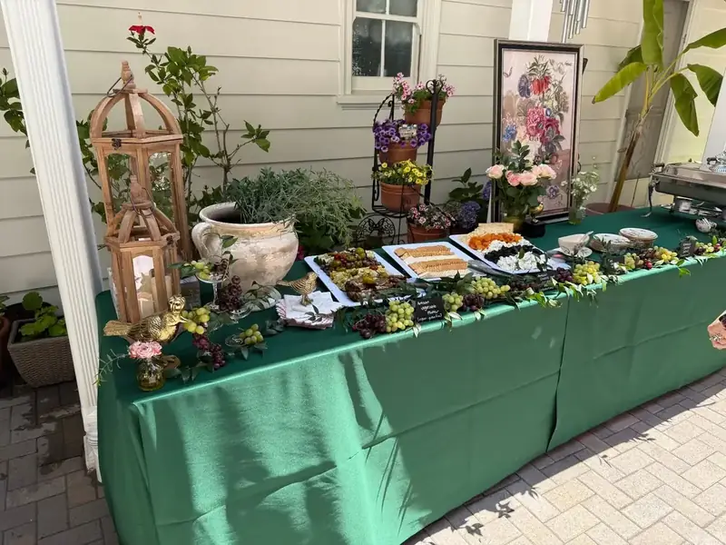 Palo Alto Catering Company’s sophisticated grazing display featuring artisan food trays, fresh fruit, botanicals, and vintage accents.
